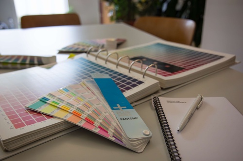 Color fan, notepad and pen on a table