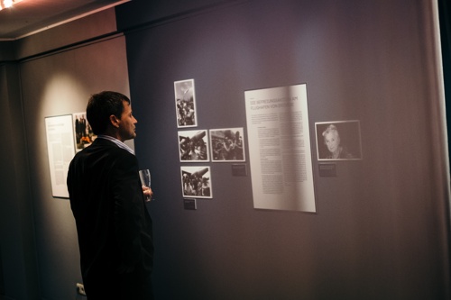 A person looks at an exhibition panel