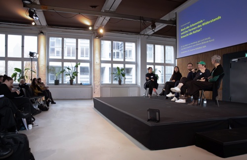 Panel discussion at Open Arts Bub Berlins first symposium with stage backdrop